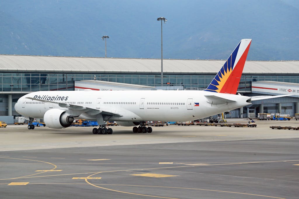 Philippine Airlines Boeing 777 parked on the airport runway, ready for the next flight.